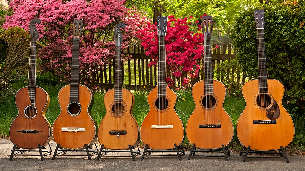 A lineup of early American acoustic guitars.
